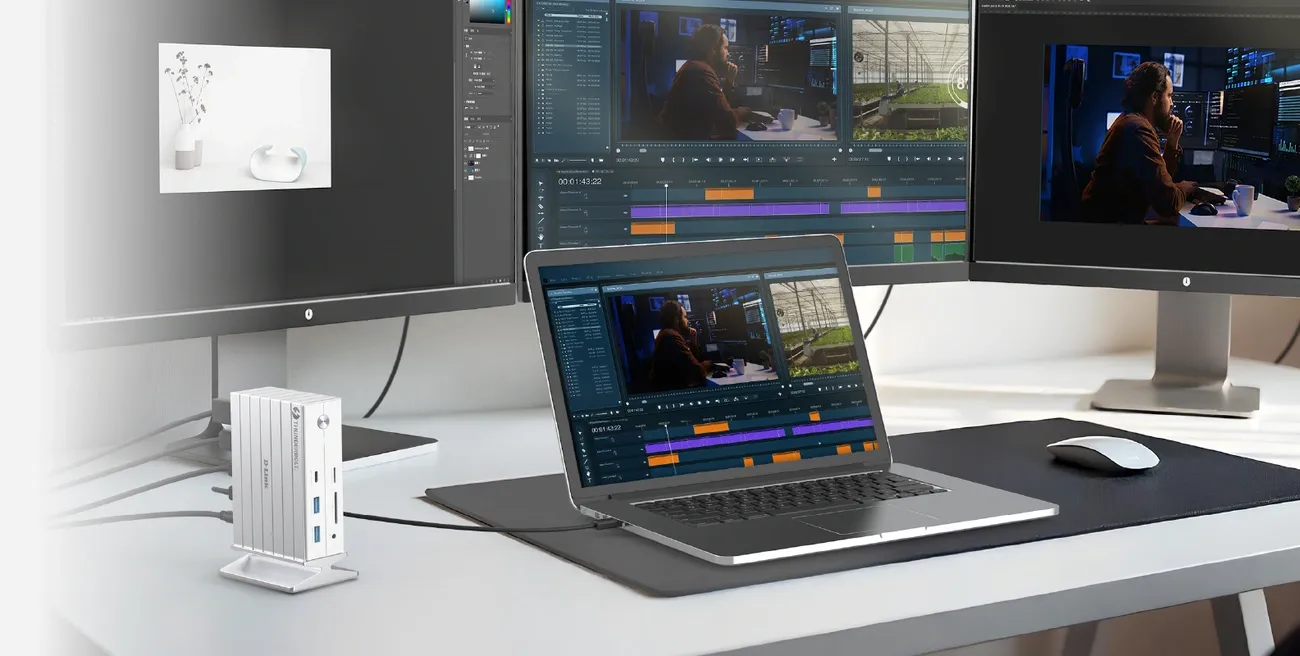 Workspace with a laptop connected to two large monitors and a D-Link DUF-E01 14-in-1 Thunderbolt 4 docking station.